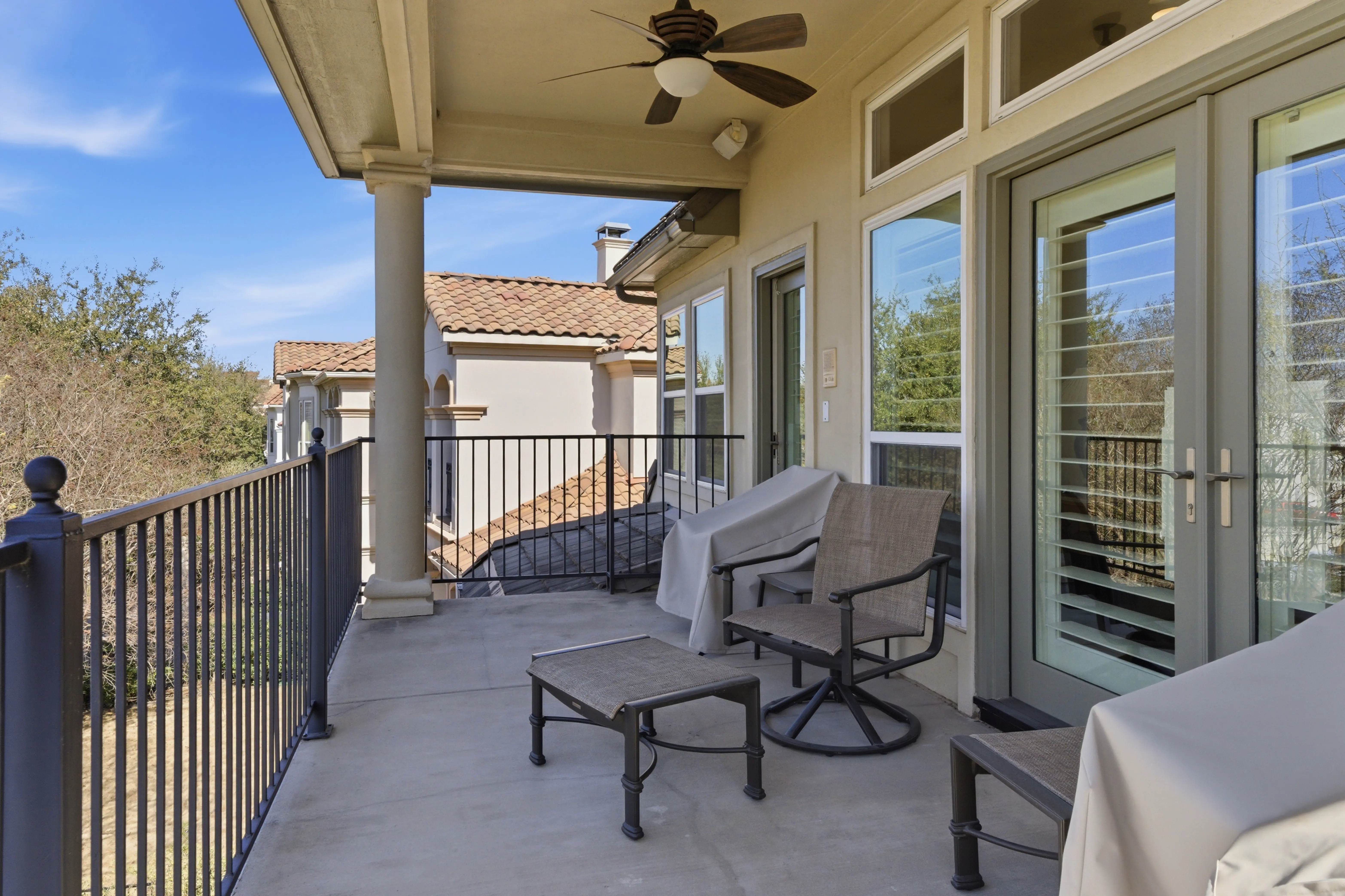 Covered second-story balcony with columns overlooking Fairway Vista